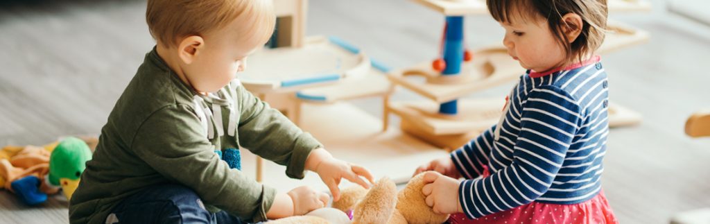 Kids are playing with teddy together - Wimbledon house nursery