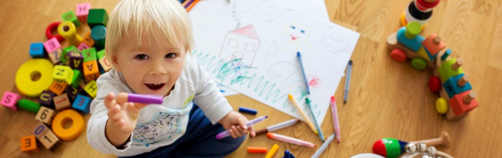 A kid is drawing and learning some new activities - Wimbledon house nursery